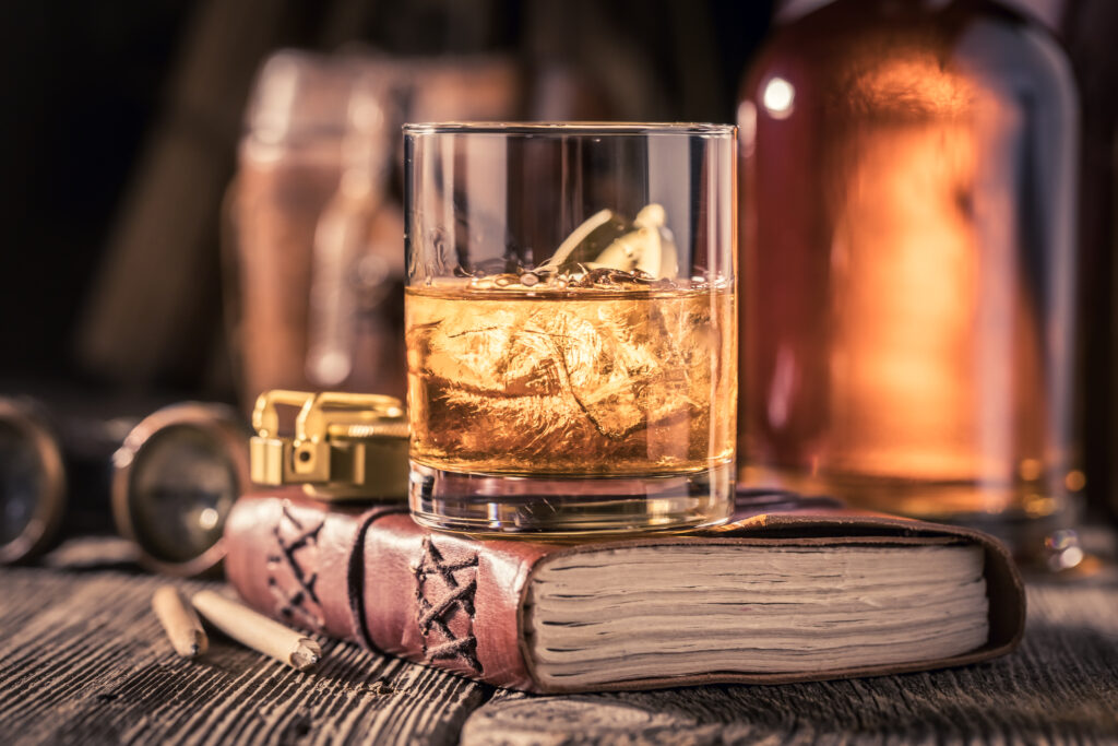 glass of whisky with journal compass and binocula 2022 04 05 07 34 44 utc